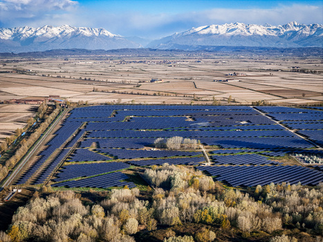 Trino Italy 30 March 2026 Aerial view of the extensive Impianto Fotovoltaico solar farm basking under a clear sky juxtaposed against the distant snow capped Alps. Trino Italy 30 March 2026 Aerial view of the extensive Impianto Fotovoltaico solar farm basking under a clear sky juxtaposed against the distant snow capped Alps.