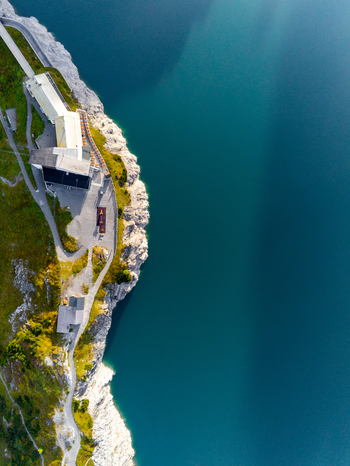 Aerial view of the Lunersee lake with its deep blue waters and the surrounding mountain lodge perched on the rocky cliff edge in Vandans Vorarlberg Austria. Aerial view of the Lunersee lake with its deep blue waters and the surrounding mountain lodge perched on the rocky cliff edge in Vandans Vorarlberg Austria.