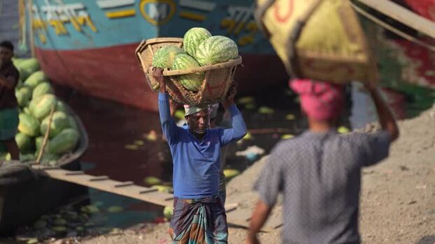 View of workers carrying watermelons at Sadarghat Bangladesh.