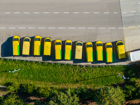 Aerial view of a row of yellow delivery vans parked at the Logistikzentrum Allhaming in Allhaming Oberosterreich Austria. Aerial view of a row of yellow delivery vans parked at the Logistikzentrum Allhaming in Allhaming Oberosterreich Austria.