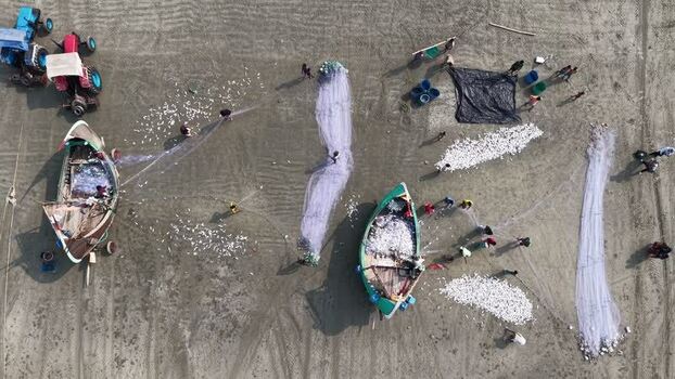 Aerial view of fishermen with boats and nets on the beach Bangladesh. Aerial view of fishermen with boats and nets on the beach Bangladesh.