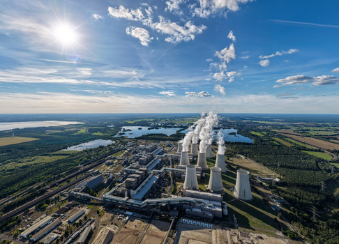 Aerial view of Janschwalde Power Station with cooling towers emitting steam surrounded by lakes and forests in Peitz Brandenburg Germany. Aerial view of Janschwalde Power Station with cooling towers emitting steam surrounded by lakes and forests in Peitz Brandenburg Germany.