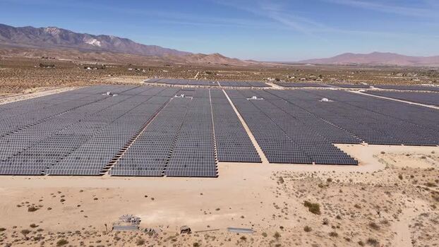 Aerial view of a large solar panel farm in the desert United States.