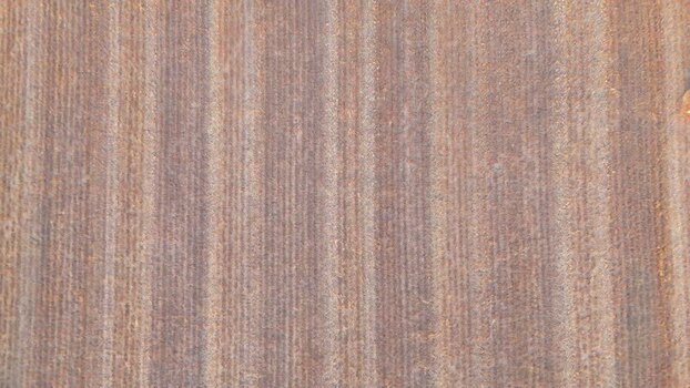 Aerial view of a plowed agricultural field with vertical furrows Switzerland.