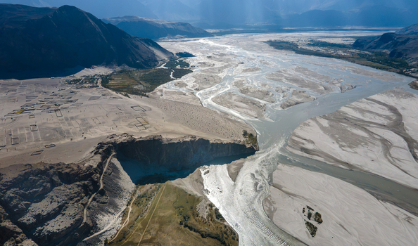 Aerial view of the Indus River flowing through the sandy landscape of Skardu Gilgit Pakistan. Aerial view of the Indus River flowing through the sandy landscape of Skardu Gilgit Pakistan.