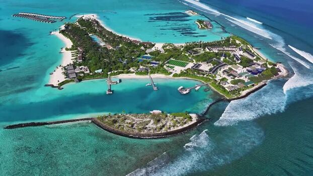 Aerial view of an island resort and reefs Thulusdhoo Maldives.
