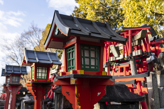View of traditional red lanterns and miniature torii gates at Fushimi Inari taisha shrine under a clear sky Kyoto Kyoto Japan.
