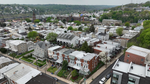 Aerial view of the Manayunk neighborhood featuring dense rows of historic brick houses tree lined streets and urban architecture in Philadelphia Pennsylvania United States.