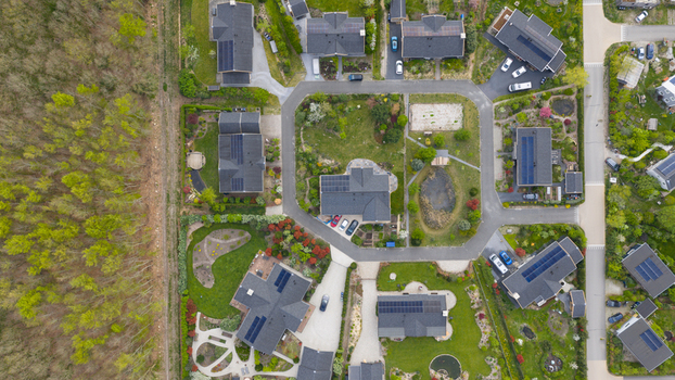 Aerial view of Ecodorp Bolderburen featuring modern sustainable houses with solar panels and lush green gardens in Almere Flevoland Netherlands. Aerial view of Ecodorp Bolderburen featuring modern sustainable houses with solar panels and lush green gardens in Almere Flevoland Netherlands.