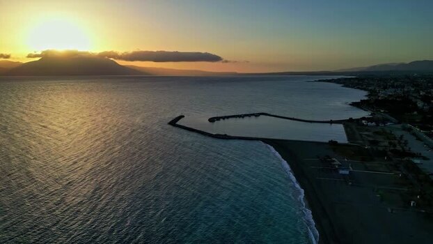Aerial view of a pier at sunset in Greece.