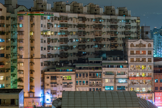 View of high density residential apartment buildings at night with illuminated windows and balconies in Sanchong District New Taipei City Taiwan. View of high density residential apartment buildings at night with illuminated windows and balconies in Sanchong District New Taipei City Taiwan.