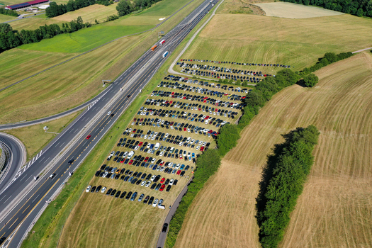 Aerial view of the Eventzentrum Strohofer Geiselwind musichall parking area filled with cars next to the highway and green fields in Geiselwind Bayern Germany. Aerial view of the Eventzentrum Strohofer Geiselwind musichall parking area filled with cars next to the highway and green fields in Geiselwind Bayern Germany.