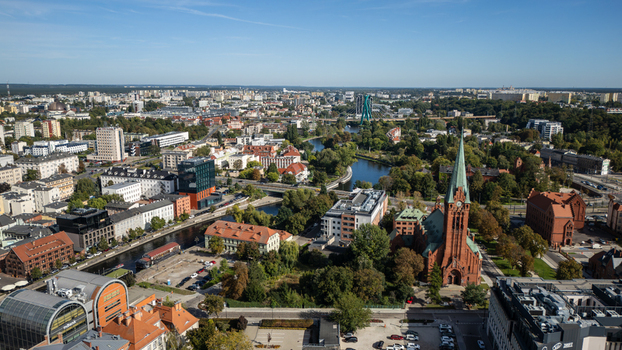 Aerial view of the striking red brick church spires piercing the skyline amidst a tapestry of buildings and waterways a vibrant urban panorama Bydgoszcz Województwo kujawsko pomorskie Poland. Aerial view of the striking red brick church spires piercing the skyline amidst a tapestry of buildings and waterways a vibrant urban panorama Bydgoszcz Województwo kujawsko pomorskie Poland.