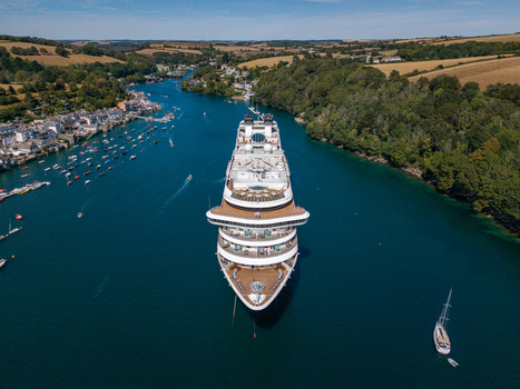 Fowey Cornwall United Kingdom 10 August 2026 Aerial view of a large cruise ship navigating the Fowey River surrounded by lush green hills small boats and the historic town of Fowey. Fowey Cornwall United Kingdom 10 August 2026 Aerial view of a large cruise ship navigating the Fowey River surrounded by lush green hills small boats and the historic town of Fowey.