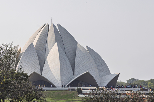 View of the Lotus Temple a modern architectural marvel with its pristine white petals reaching skyward amidst the lush greenery New Delhi Delhi India. View of the Lotus Temple a modern architectural marvel with its pristine white petals reaching skyward amidst the lush greenery New Delhi Delhi India.
