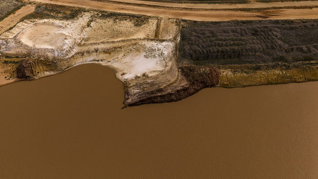 Aerial view of industrial salt mining patterns with brown water sand deposits and textured earth near Useless Loop in Kalbarri Western Australia Australia. Aerial view of industrial salt mining patterns with brown water sand deposits and textured earth near Useless Loop in Kalbarri Western Australia Australia.
