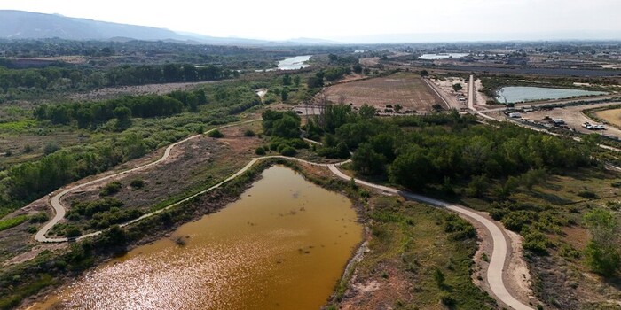 Grand Junction Colorado United States 03 July 2026 Aerial view of retention ponds surrounded by walking paths lush greenery and dry landscape under a clear sky. Grand Junction Colorado United States 03 July 2026 Aerial view of retention ponds surrounded by walking paths lush greenery and dry landscape under a clear sky.