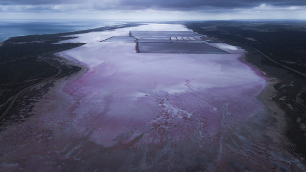 Aerial view of the vibrant pink salt lake with industrial salt pans and surrounding coastal landscape in Kalbarri Western Australia Australia. Aerial view of the vibrant pink salt lake with industrial salt pans and surrounding coastal landscape in Kalbarri Western Australia Australia.
