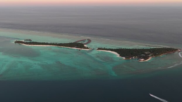 Aerial view of a luxury resort island and coral reefs Maldives.
