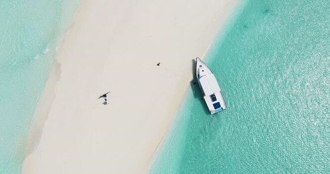 Aerial view of a boat moored at a white sandbar Maldives. Aerial view of a boat moored at a white sandbar Maldives.