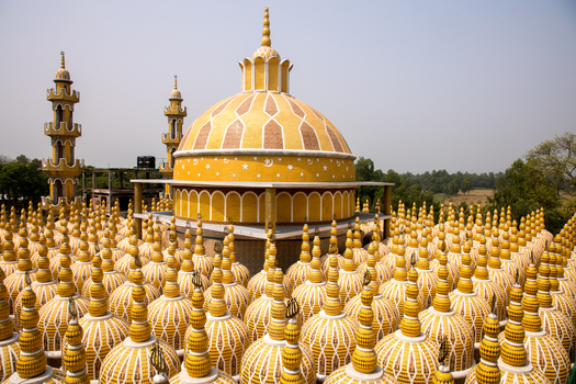 View of a golden hued mosque with ornate domes and minarets rises majestically against a soft sky a testament to architectural grandeur Tangail Bangladesh. View of a golden hued mosque with ornate domes and minarets rises majestically against a soft sky a testament to architectural grandeur Tangail Bangladesh.