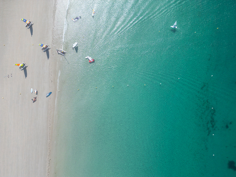 Aerial view of colorful sailboats and catamarans on a sandy beach and in the turquoise water of the coast in Trebeurden Brittany France. Aerial view of colorful sailboats and catamarans on a sandy beach and in the turquoise water of the coast in Trebeurden Brittany France.