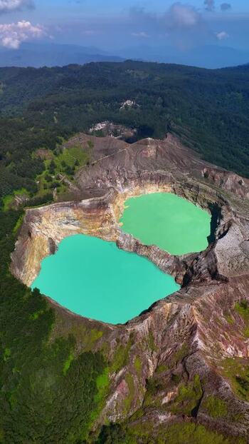 Aerial view of Kelimutu National Park crater lakes and forest Indonesia. Aerial view of Kelimutu National Park crater lakes and forest Indonesia.