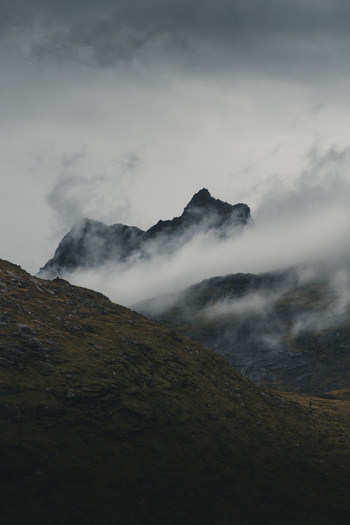 View of the dramatic cloud covered peaks of the Lofoten mountains in Nordland Norway.