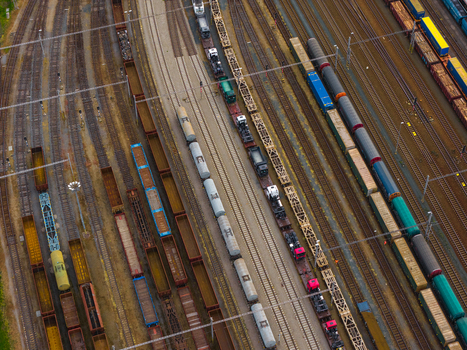 Aerial view of a busy railway yard featuring numerous freight trains with cargo cars and tankers parked on parallel tracks in Breclav South Moravian Region Czechia.