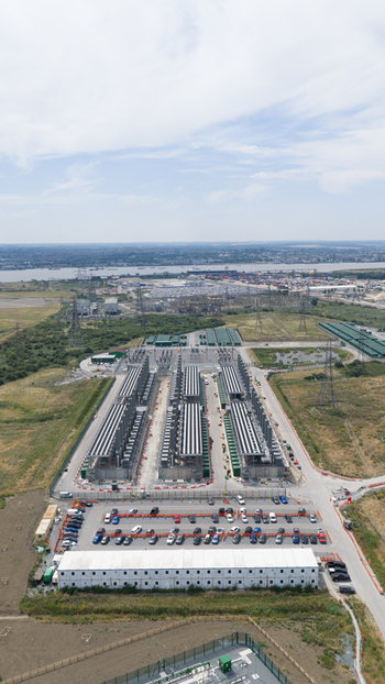 Aerial view of Thurrock Flexible Generation Substation with rows of power generation units a warehouse and a parking lot in an industrial area in Tilbury England United Kingdom.