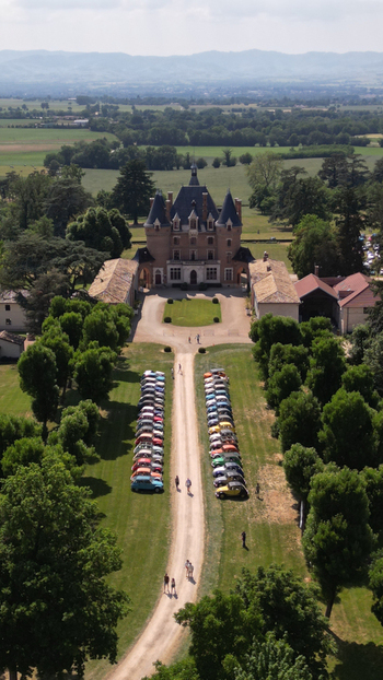 Francheleins France 04 June 2023 Aerial view of Chateau de Vataneins with rows of vintage cars parked on the lawn and people walking along the driveway under a clear sky. Francheleins France 04 June 2023 Aerial view of Chateau de Vataneins with rows of vintage cars parked on the lawn and people walking along the driveway under a clear sky.