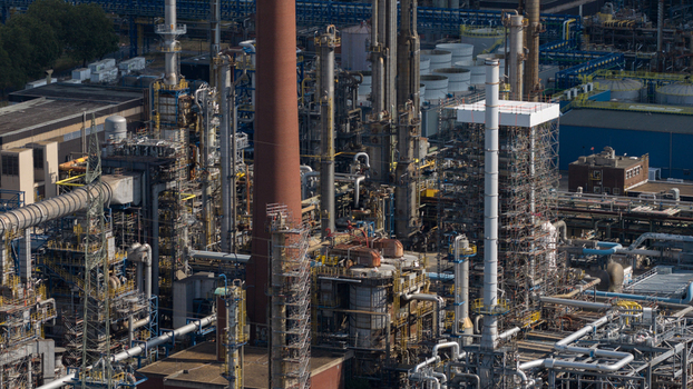 Aerial view of the Tanklager industrial facility featuring complex piping tall chimneys and storage tanks in Gelsenkirchen North Rhine Westphalia Germany.
