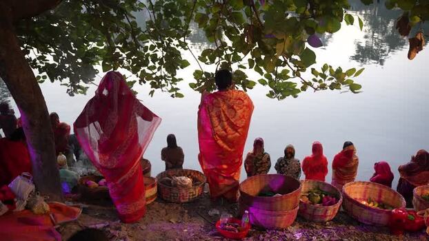 View of people with offerings by a riverbank in Bogura Bangladesh. View of people with offerings by a riverbank in Bogura Bangladesh.