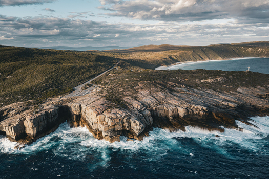 Aerial view of The Gap a dramatic rock formation with crashing waves rugged cliffs and coastal vegetation in Torndirrup Western Australia Australia. Aerial view of The Gap a dramatic rock formation with crashing waves rugged cliffs and coastal vegetation in Torndirrup Western Australia Australia.