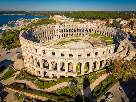 Aerial view of the ancient Roman amphitheater a magnificent stone structure stands proudly against the backdrop of the Adriatic Sea Pula Istria County Croatia.