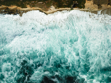 Aerial view of turquoise waves crashing against the rocky cliffs of La Jolla Cove in San Diego California United States. Aerial view of turquoise waves crashing against the rocky cliffs of La Jolla Cove in San Diego California United States.