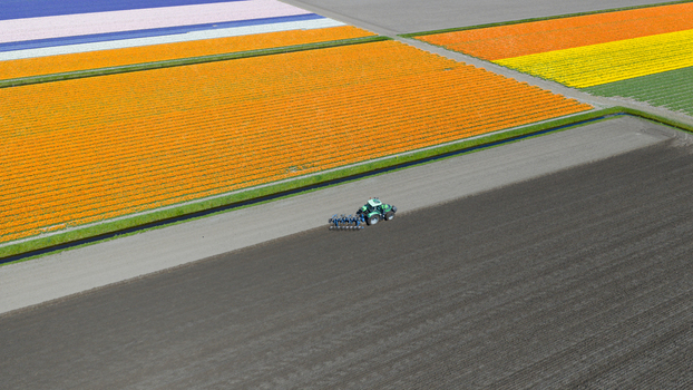 Aerial view of a green tractor plowing dark soil adjacent to vibrant orange and purple tulip fields under bright daylight Heiloo North Holland Netherlands. Aerial view of a green tractor plowing dark soil adjacent to vibrant orange and purple tulip fields under bright daylight Heiloo North Holland Netherlands.