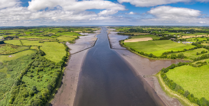 Aerial view of the River Moy flowing through lush green fields and agricultural landscapes in Ballina County Mayo Ireland.