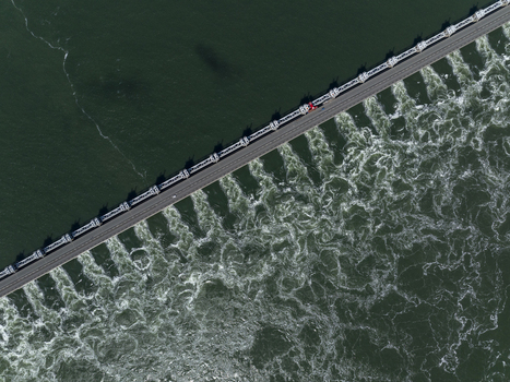 Aerial view of Eastern Scheldt Storm Surge Barrier with turbulent water flowing through the sluice gates Vrouwenpolder Zeeland Netherlands. Aerial view of Eastern Scheldt Storm Surge Barrier with turbulent water flowing through the sluice gates Vrouwenpolder Zeeland Netherlands.