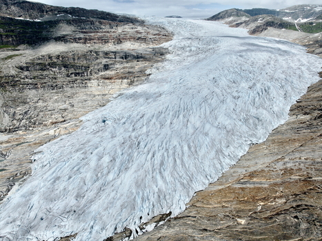 Aerial view of the Svartisen glacier within Saltfjellet Svartisen National Park showcasing deep crevasses icy textures and rugged mountain terrain in Rana Municipality Nordland Norway.