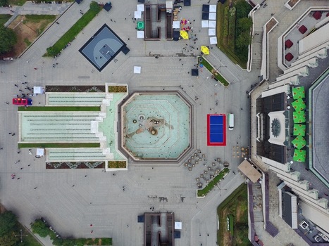 Aerial view of the NDK square featuring an octagonal fountain geometric paving patterns and people walking around the National Palace of Culture in Sofia Sofia City Province Bulgaria. Aerial view of the NDK square featuring an octagonal fountain geometric paving patterns and people walking around the National Palace of Culture in Sofia Sofia City Province Bulgaria.