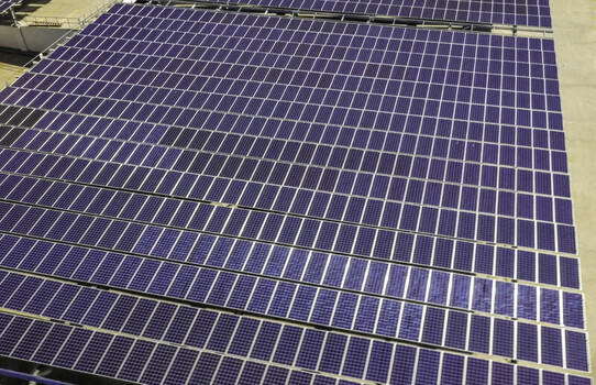Aerial view of a large solar panel array installed on top of a parking structure in Los Angeles CA United States. Aerial view of a large solar panel array installed on top of a parking structure in Los Angeles CA United States.