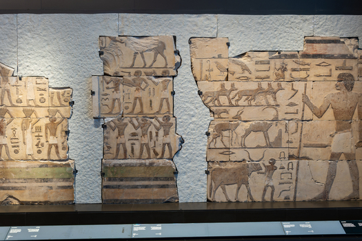 Giza Egypt 16 May 2026 View of ancient Egyptian relief carvings depicting figures and animals on stone blocks at the Grand Egyptian Museum.