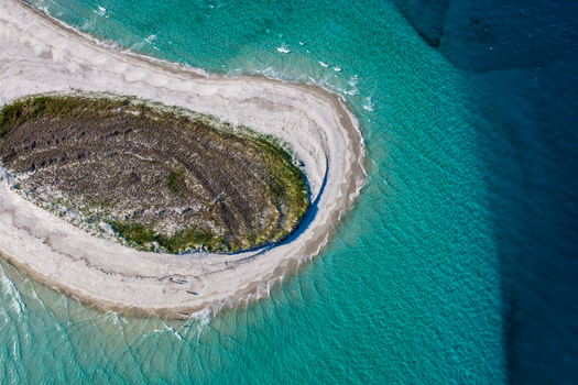 Aerial view of Pelican Bank at K gari featuring white sandbars turquoise shallow waters and deep blue ocean currents K gari Queensland Australia. Aerial view of Pelican Bank at K gari featuring white sandbars turquoise shallow waters and deep blue ocean currents K gari Queensland Australia.