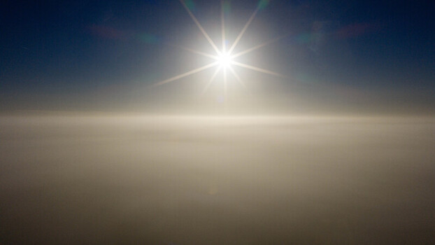 Aerial view of a thick layer of clouds illuminated by the bright sun above in Salisbury England United Kingdom. Aerial view of a thick layer of clouds illuminated by the bright sun above in Salisbury England United Kingdom.