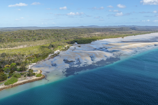 Aerial view of coastline at Amity Point on Minjerribah North Stradbroke Island featuring sandy tidal flats mangroves and turquoise waters of Moreton Bay Amity Point Queensland Australia. Aerial view of coastline at Amity Point on Minjerribah North Stradbroke Island featuring sandy tidal flats mangroves and turquoise waters of Moreton Bay Amity Point Queensland Australia.