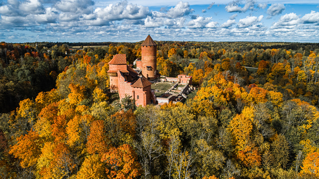Aerial view of Turaida Castle surrounded by vibrant autumn foliage and dense forest in Sigulda Sigulda Municipality Latvia. Aerial view of Turaida Castle surrounded by vibrant autumn foliage and dense forest in Sigulda Sigulda Municipality Latvia.