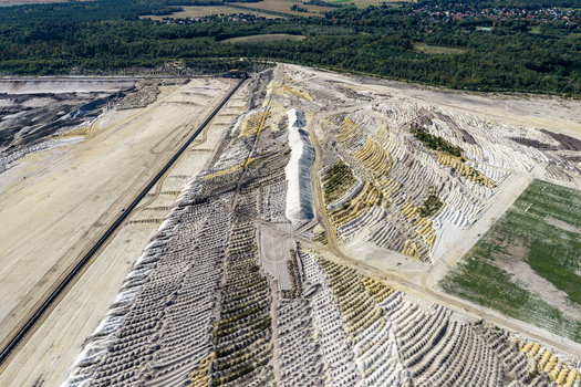 Aerial view of Tagebau Welzow Sud brown coal open pit mine showing extensive terraced earthworks and industrial excavation patterns in Spremberg Brandenburg Germany. Aerial view of Tagebau Welzow Sud brown coal open pit mine showing extensive terraced earthworks and industrial excavation patterns in Spremberg Brandenburg Germany.