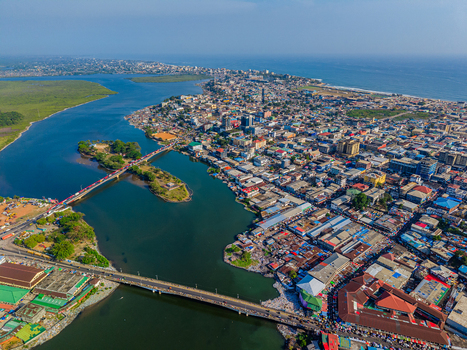 Aerial view of the urban landscape and bridges crossing the Mesurado River with colorful rooftops and the Atlantic Ocean in the distance Monrovia Montserrado Liberia. Aerial view of the urban landscape and bridges crossing the Mesurado River with colorful rooftops and the Atlantic Ocean in the distance Monrovia Montserrado Liberia.