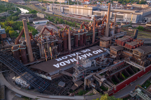 Volklingen Germany 09 May 2026 Aerial view of the Volklingen Ironworks featuring rusty industrial structures tall chimneys and a large roof with white text under evening light. Volklingen Germany 09 May 2026 Aerial view of the Volklingen Ironworks featuring rusty industrial structures tall chimneys and a large roof with white text under evening light.